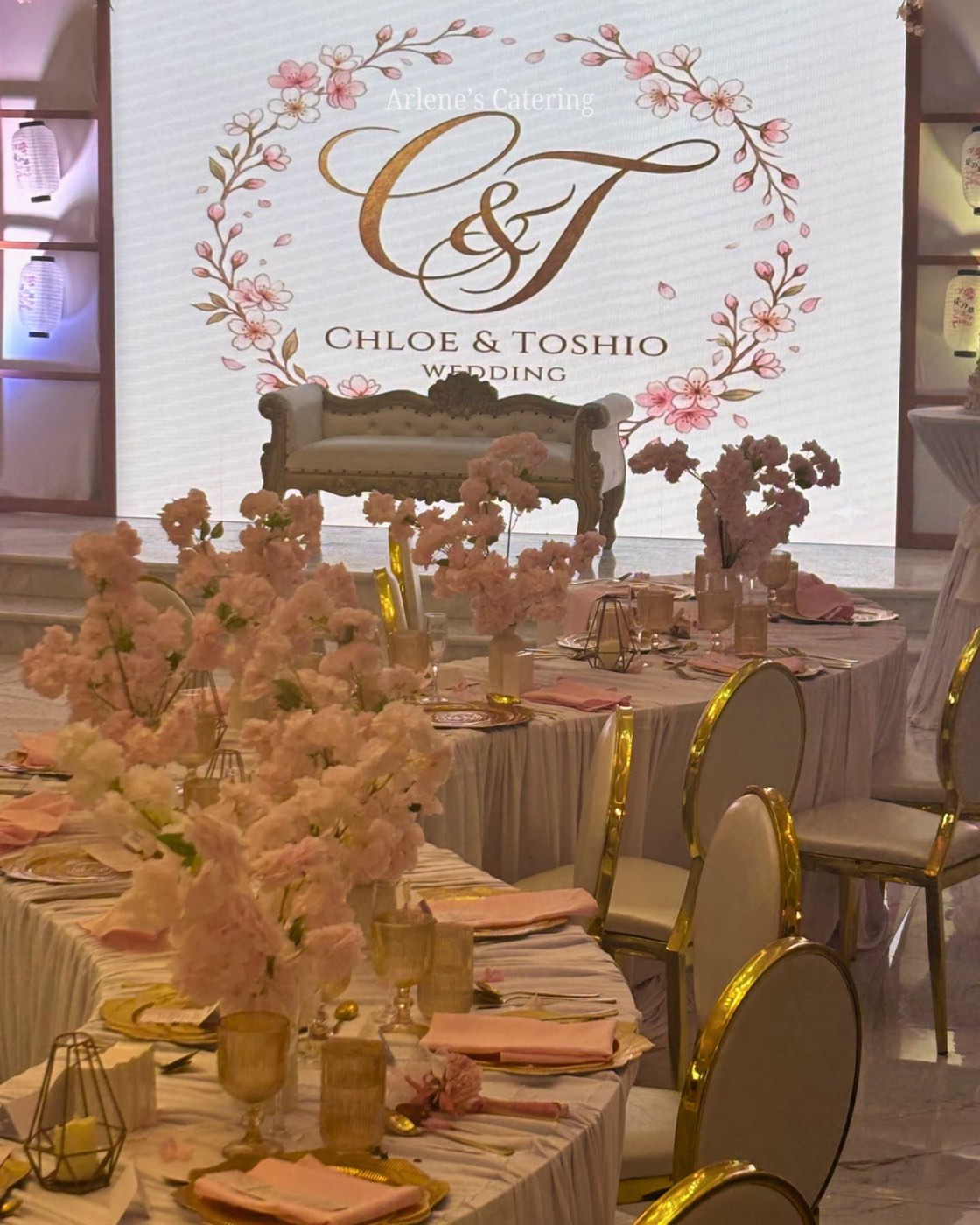 A real cherry-blossom wedding monogram backdrop reading Chloe and Toshio Wedding