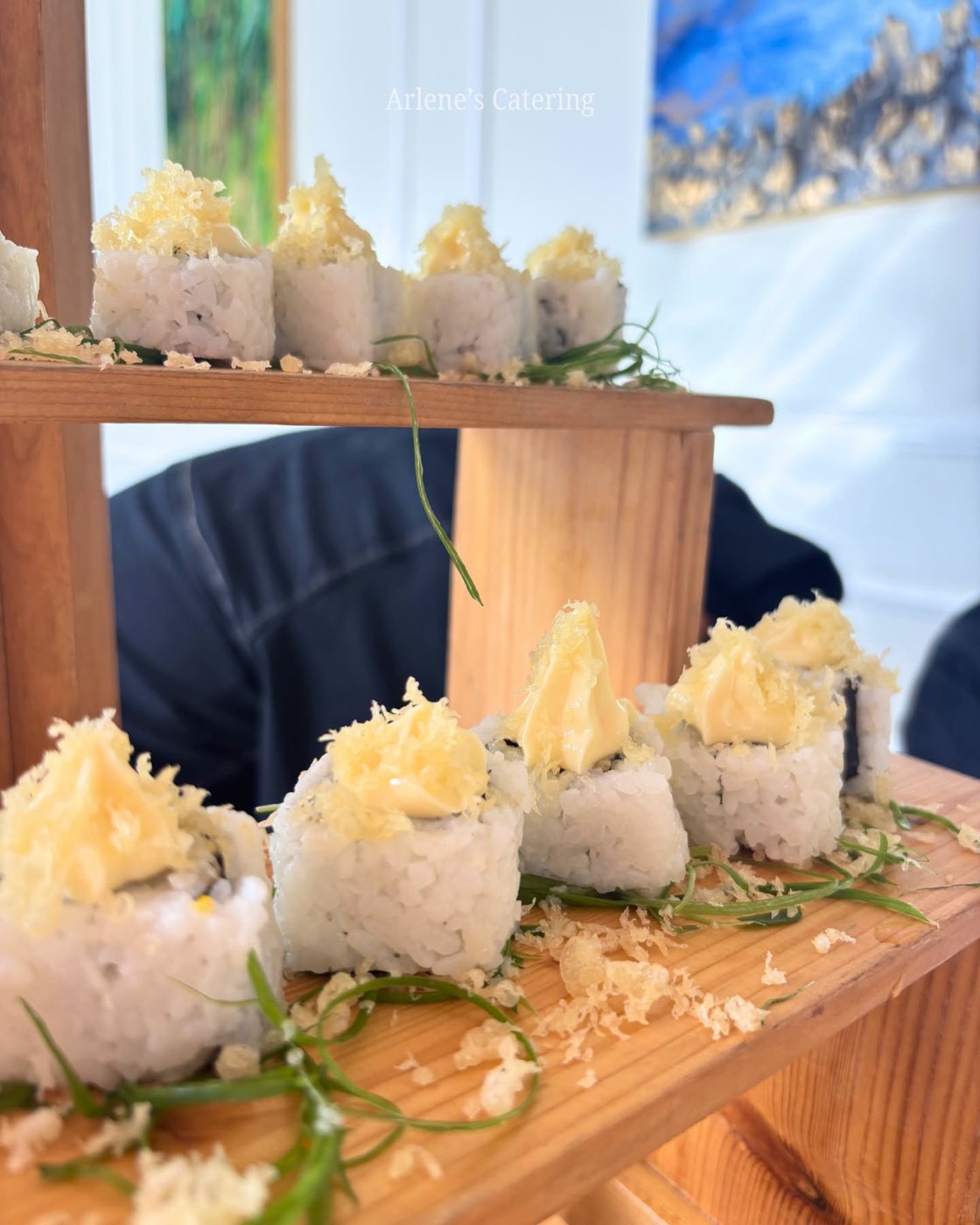 Food plated in individual boat-shaped trays on a wood stand