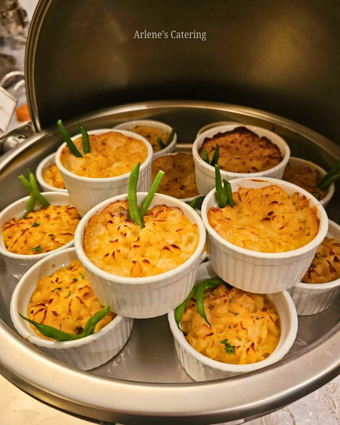 Individual leche flan cups on a dessert tray