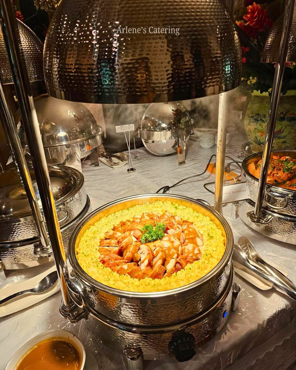 A creamy seafood pasta dish in a catering chafing tray